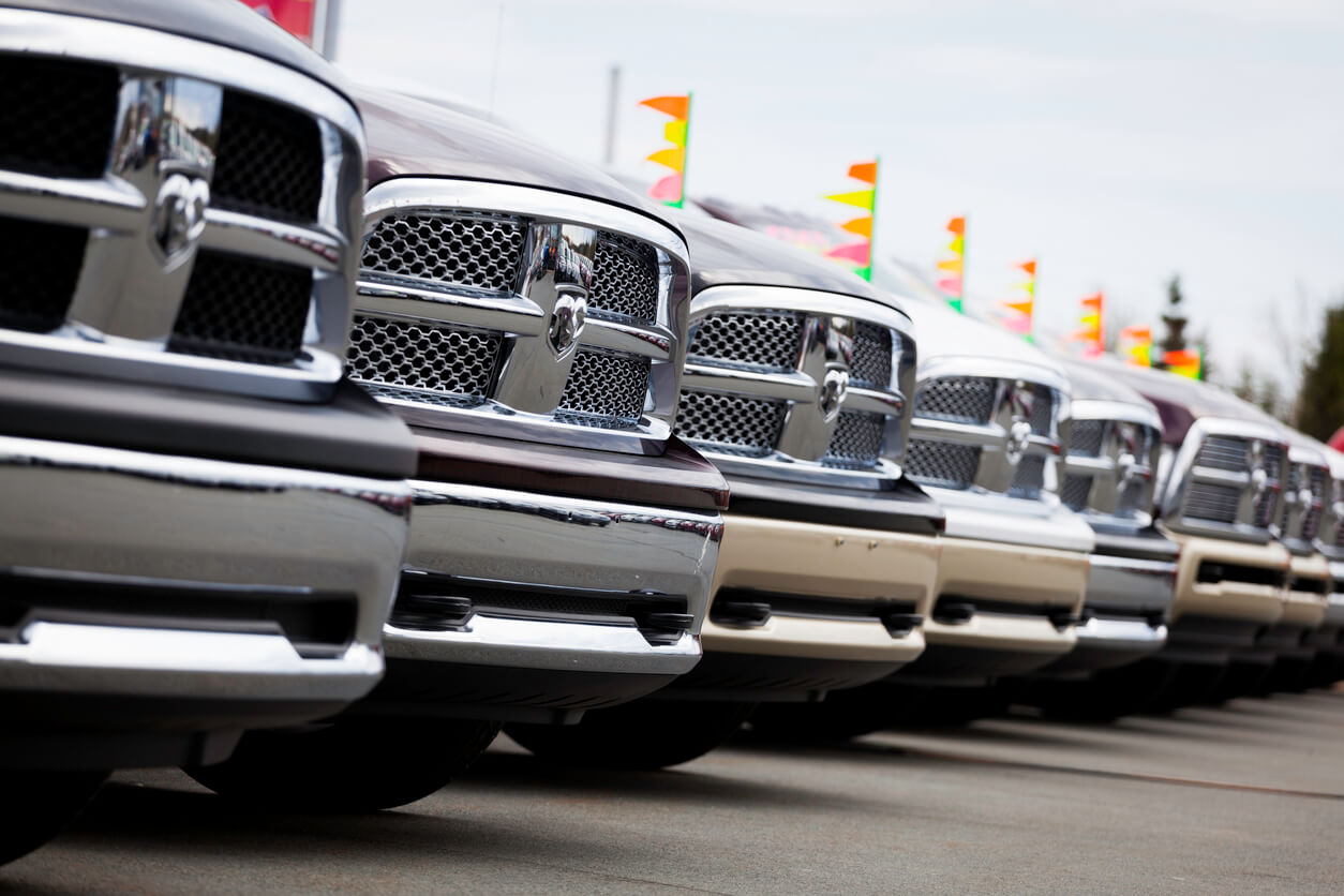 Dodge RAM trucks lined up at dealership.